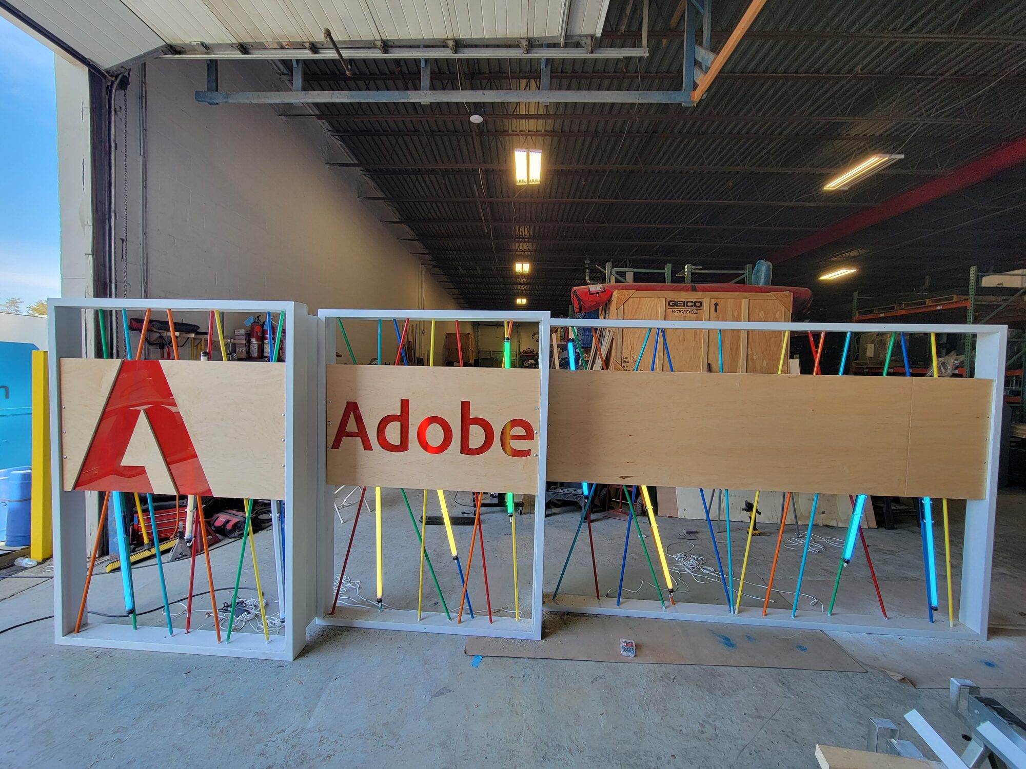 The three assembled walls from a second angle, showing the third panel with monitors and tablets not yet powered on