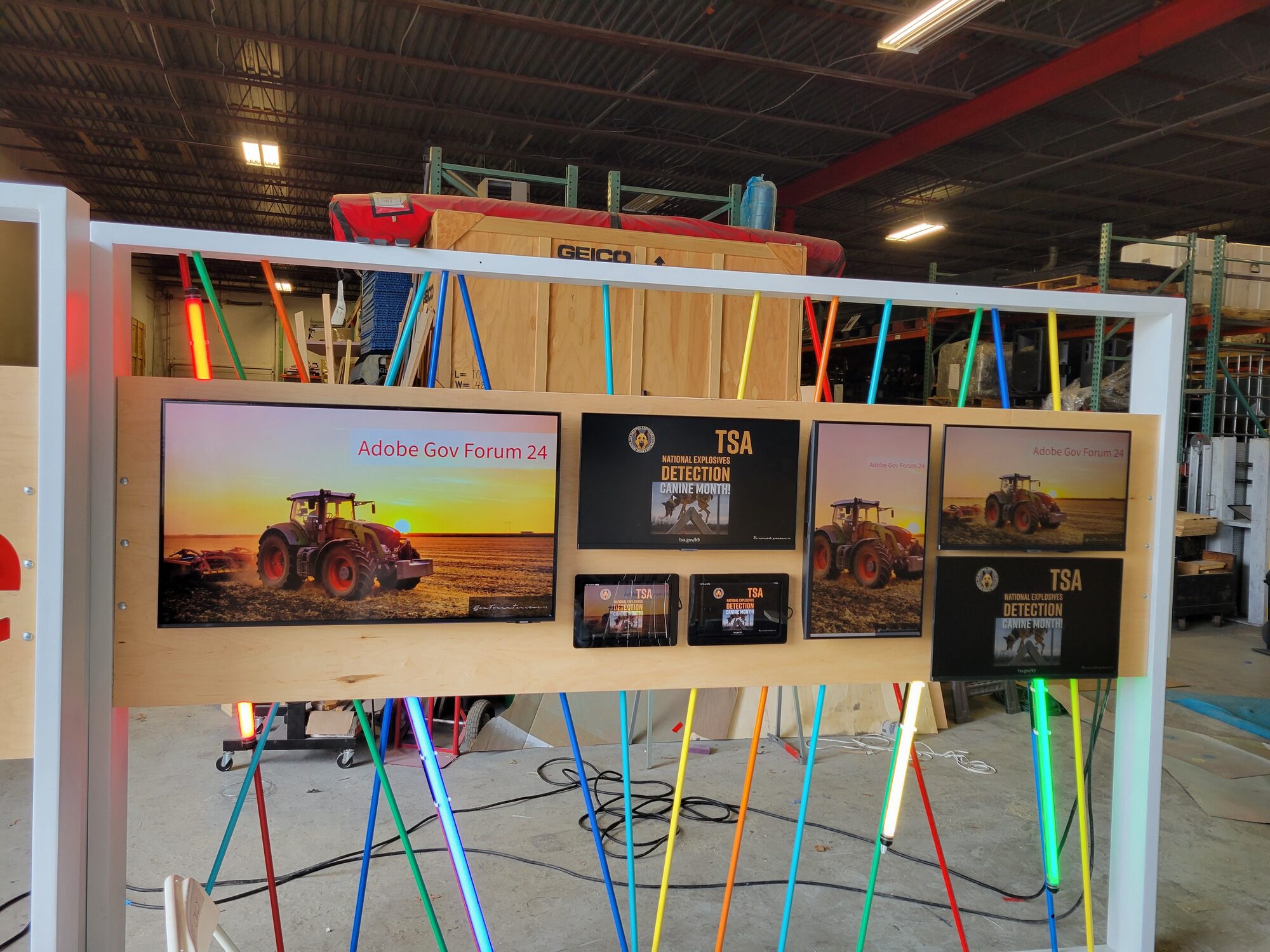 The fully assembled and lit activation staged in the shop with iMac pedestals in front, all screens live