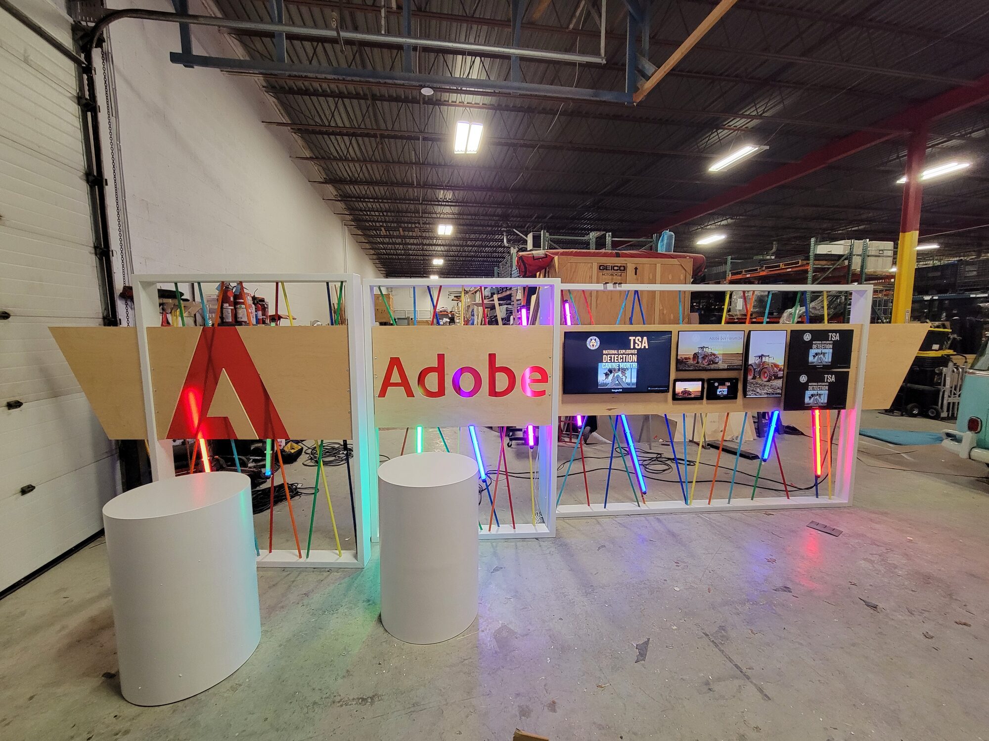 The fully assembled and lit activation from a second angle, all three walls and both iMac pedestals visible
