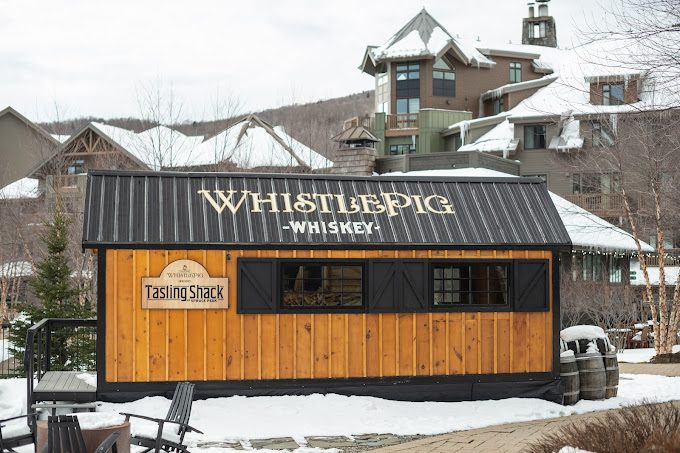 Finished Tasting Shack exterior with WhistlePig Whiskey signage in the snow